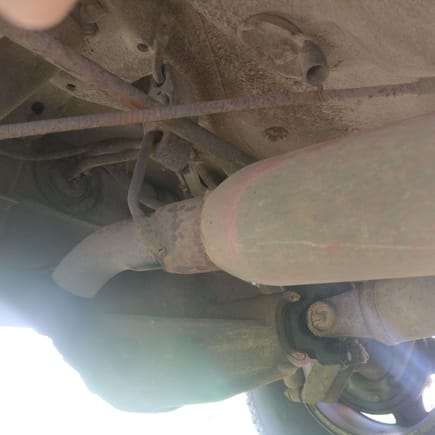 No muffler, just ends prior to the rear axle
