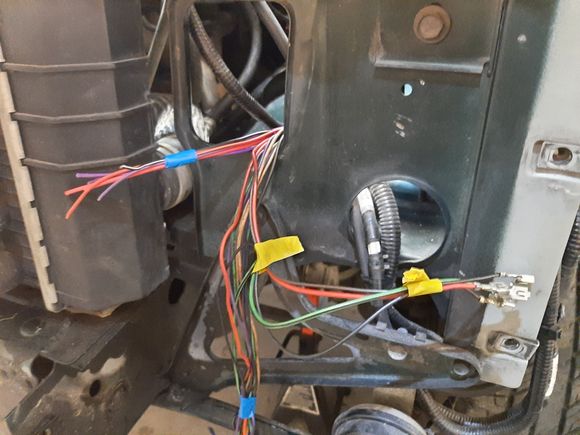 Heres the wires from the PDC. Its gauged appropriately and color matched to the OEM wires going into what used to be the H4 harness. Ypu can also see the terminals for the fog light relay. Right here between the OEM harness and the auxiliary PDC is going to be a connector.