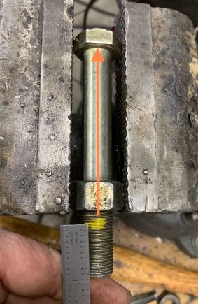 Move over to the beach vise. Thread a spare nut past where the hole will end up. Align the bolt so that the hole will be inline with a flat on the bolt head hex. This is important for drilling, you’ll see why.
