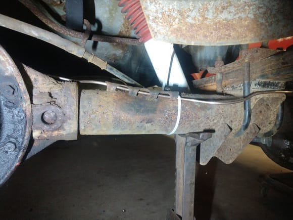 Put in the tie down to replace the old one that was there, and put on the bracket for the brake line to secure it to the axle!
