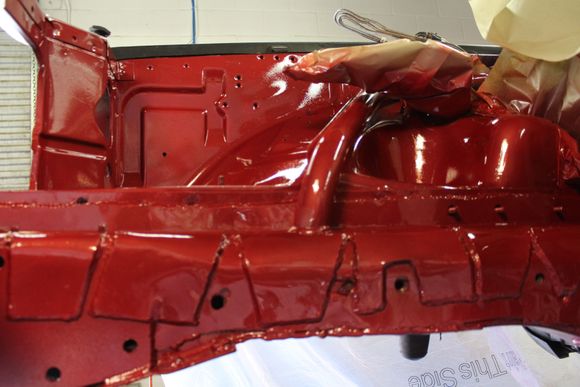 This shows the beginnings of the roll cage., Just before paint I bent and welded in the beginnings of a roll cage, started with a  tube from the newly supported frame rail. connected it up along the spring perch.  Turned it at the upper edge of the inner fender and ran it back toward the firewall.