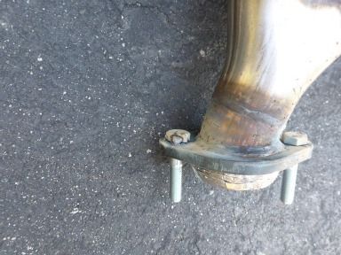 Muffler guy once said tack welding the bolts to the flange makes installation a breeze.  So I did.