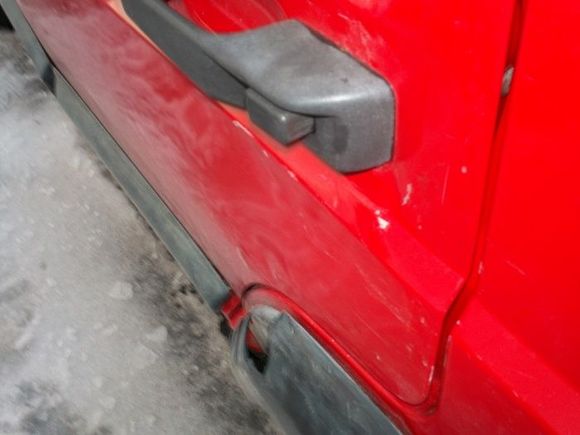 Hard to see, but the handle is pushed in and the door is dented fairly well below the handle