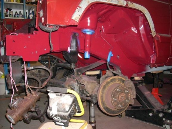 Red Jeep
The JKS power steering stiffeners welded in. Going into Intense frame stiffeners and finishing up with the TNT frame rail stiffeners shown welded in but still in gray primer. Fender flair not installed yet. This is the old axel but now have axel from 1999 painted and installed.