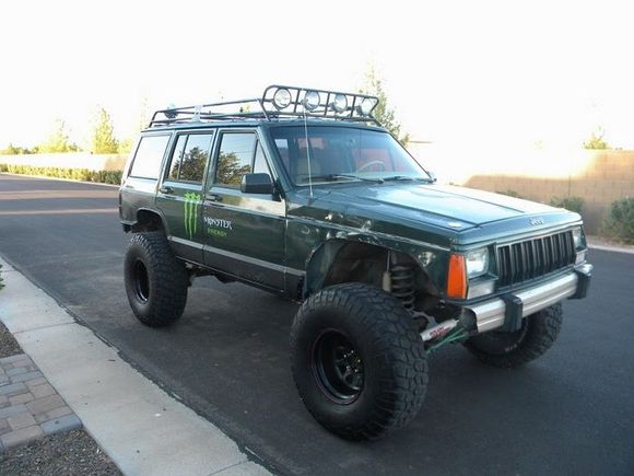 rear wells are folded, and the fronts look like they stuffed the tire before removing the fender flares. Already straightened the doors so they close properly. Again - hate the stickers!