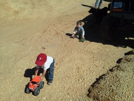 Boy practicing wheeling with monster trucks.