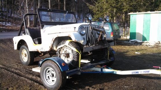 My buddy bought this the other day.  It's a 1961, I believe it's technically called a Willys, but I don't know much about these.  It has a 4 cylinder and is built like a tank.  This little thing came with a huge industrial looking plow, like something you see on a medium size municipal plow truck. Appearently it moves it with no problem.