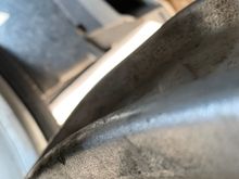 And here between the swaybar and LCA , the black area lower left of the photo 