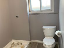 A look at the baseboard at the shower stall