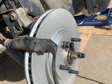 Brand new coated rotors to prevent rust , I torqued the caliper bracket bolts to 85 ft/lb and the caliper bolts to the sliders at 24 ft/lb . I made sure to pump the brake pedal several times to seat the pads to the rotors as I had retracted the caliper piston in so the new pads fit into the caliper.