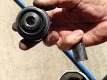 The one in the right, it’s separated from the metal barrel the bolt goes through 