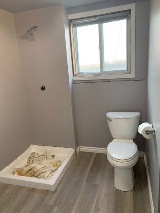 A look at the baseboard at the shower stall