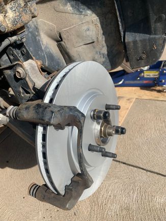 Brand new coated rotors to prevent rust , I torqued the caliper bracket bolts to 85 ft/lb and the caliper bolts to the sliders at 24 ft/lb . I made sure to pump the brake pedal several times to seat the pads to the rotors as I had retracted the caliper piston in so the new pads fit into the caliper.