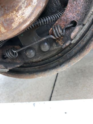 The anchor springs are a bear to remove, it looks like the backing plate and brakes are assembled then installed on the axle and then the hub is installed, lucky factory workers. 