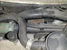 Rear upper coolant pipe and EGR valve below pipe.
