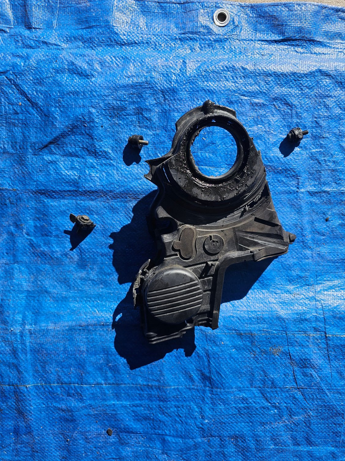 #5. Lower timing cover with plastic bolt holders completely sheared or melted off.