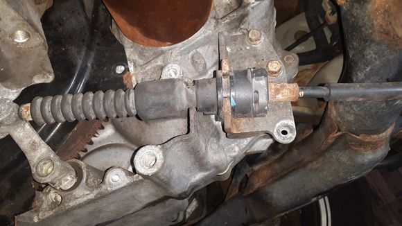 Gear selector cable grommet.  Use a pry bar or large screwdriver.
