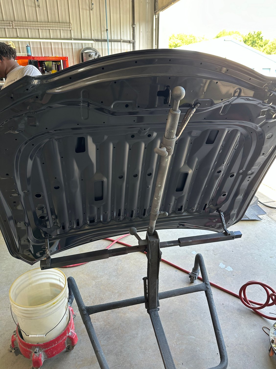New IS500 hood being cleaned and buffed just after Cloudburst Gray paint (underside) by Lexus-certified body shop.