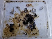 Debris in oil tensioner and bearing material