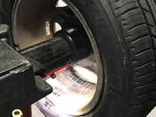 Balancing machine operator is guided where to place wheel weights by laser light.
