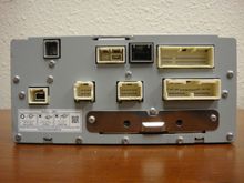 Which port should I plug? Gray one on the middle top or the white one on the button?