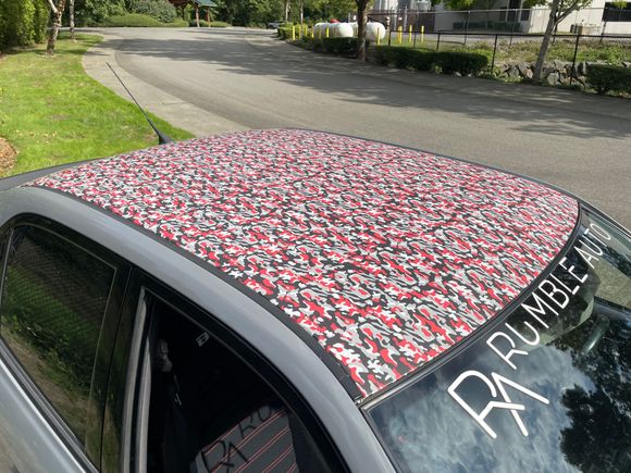 The roof is vinyl wrapped with a pattern meant to help you 'not see' the sunroof lines, which are actually a custom one-off carbon fiber plug.