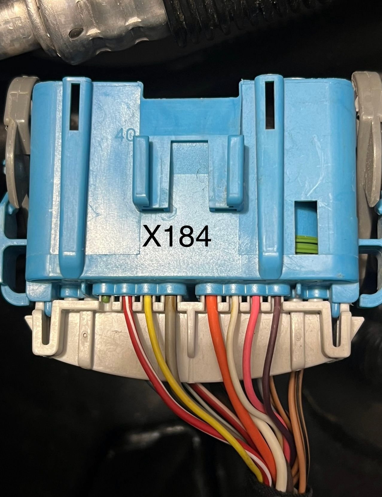Located outboard of the battery and is the biggest of the 3 connectors there