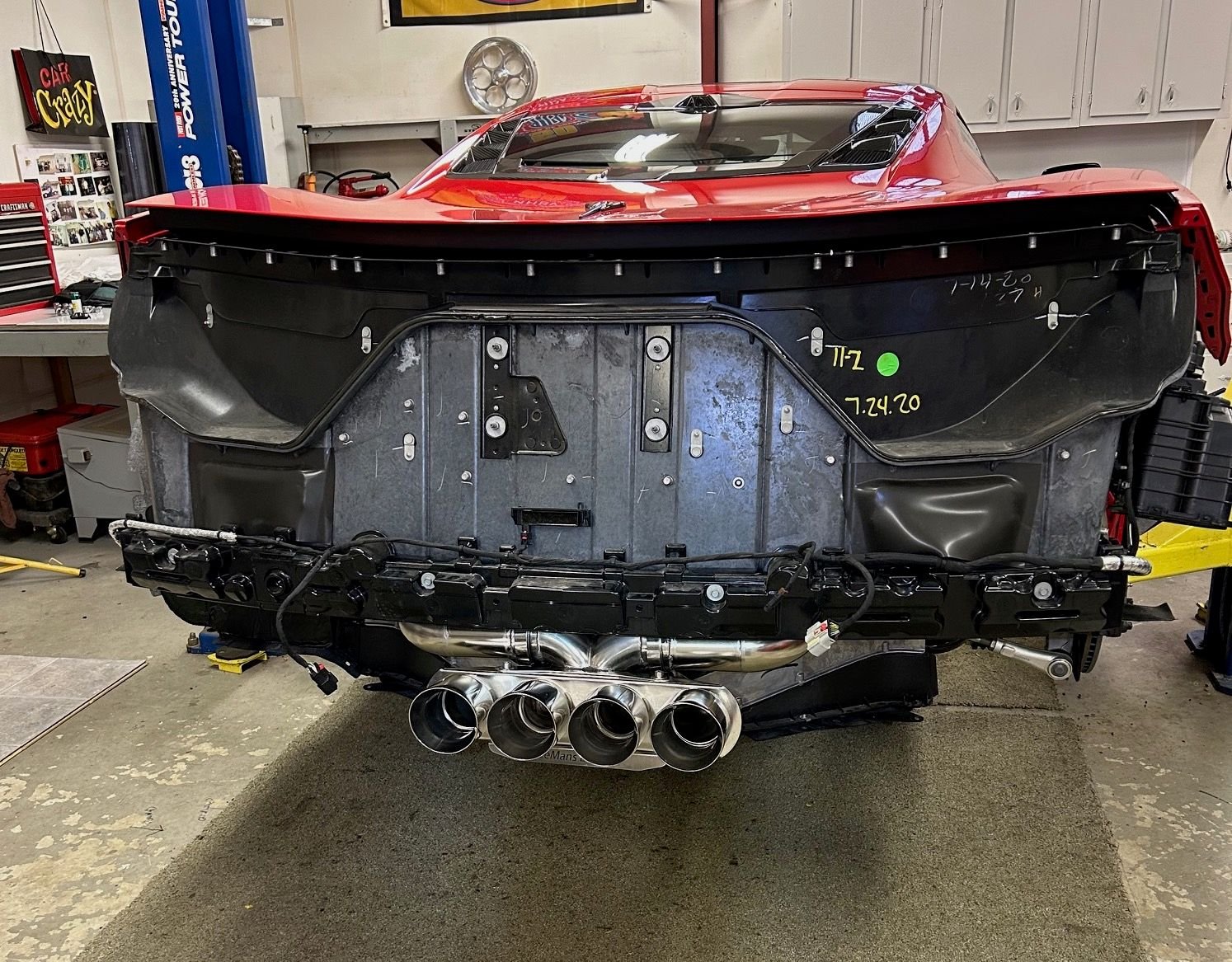 Polished set of tips with exhaust mounted on car.
