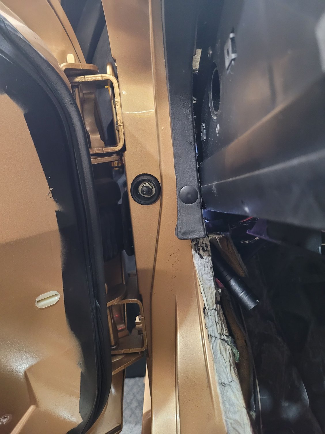Upper hinge in relation to access hole.