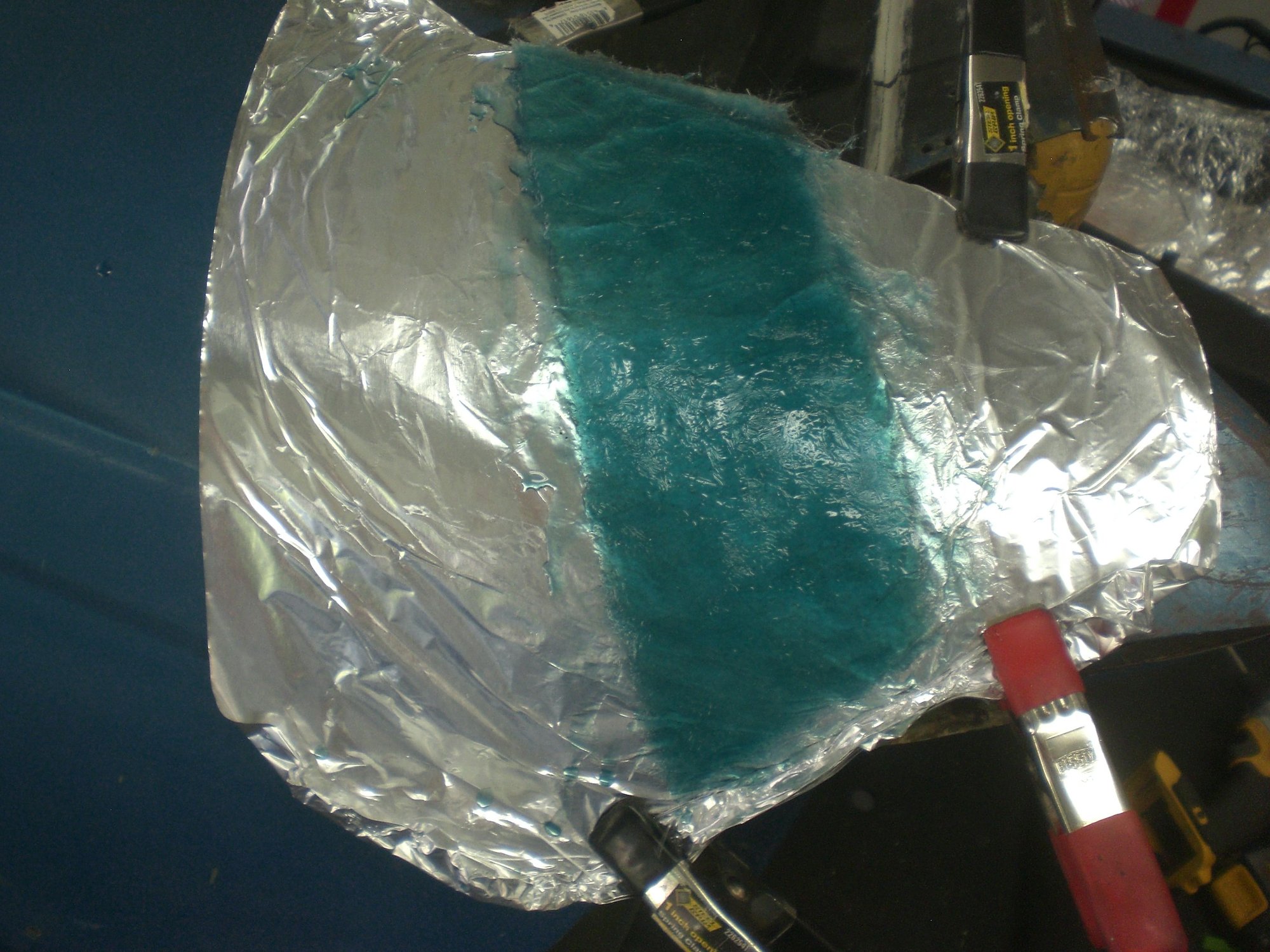 A few layers of glass matt and resin formed the bonding strip with the proper curve