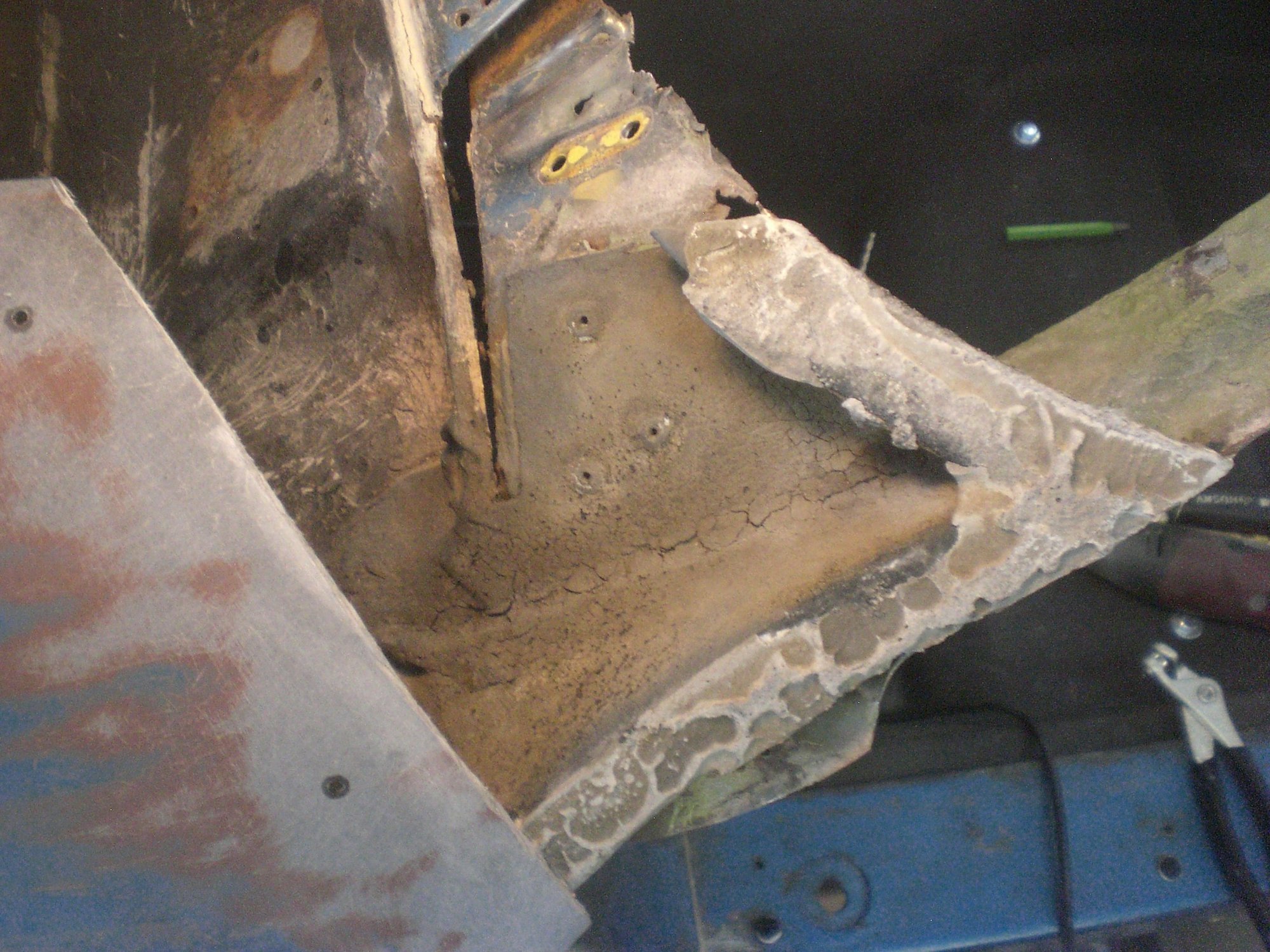 Here is the bonding support piece exposed after the fender tip was removed.  Its attached to the metal outer corner with the 3 blind rivets shown.  The actual bonding surface is shaped like the #7.  