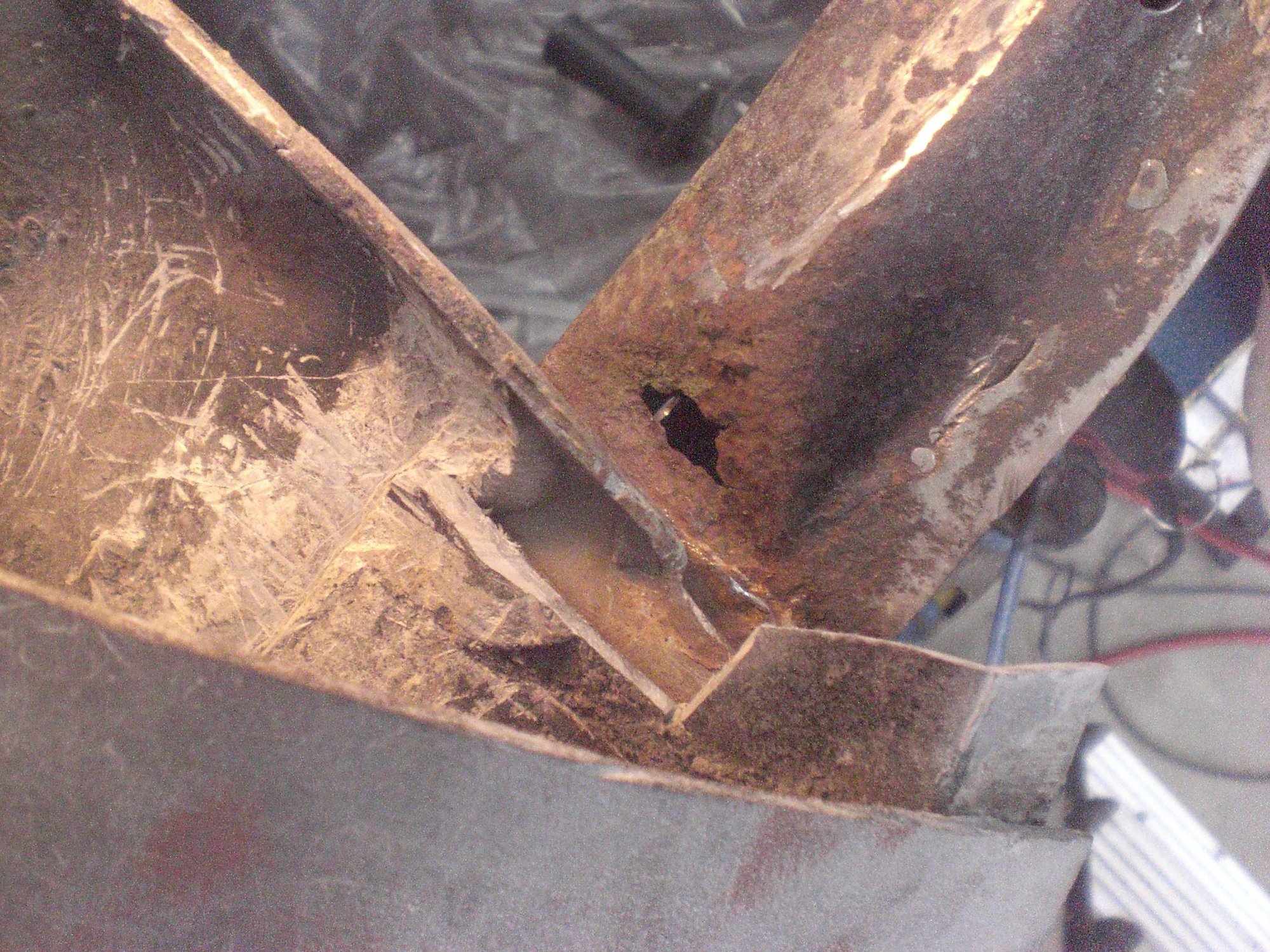 After the bonding assembly was cut and removed, damage to the hinge pillar was revealed.