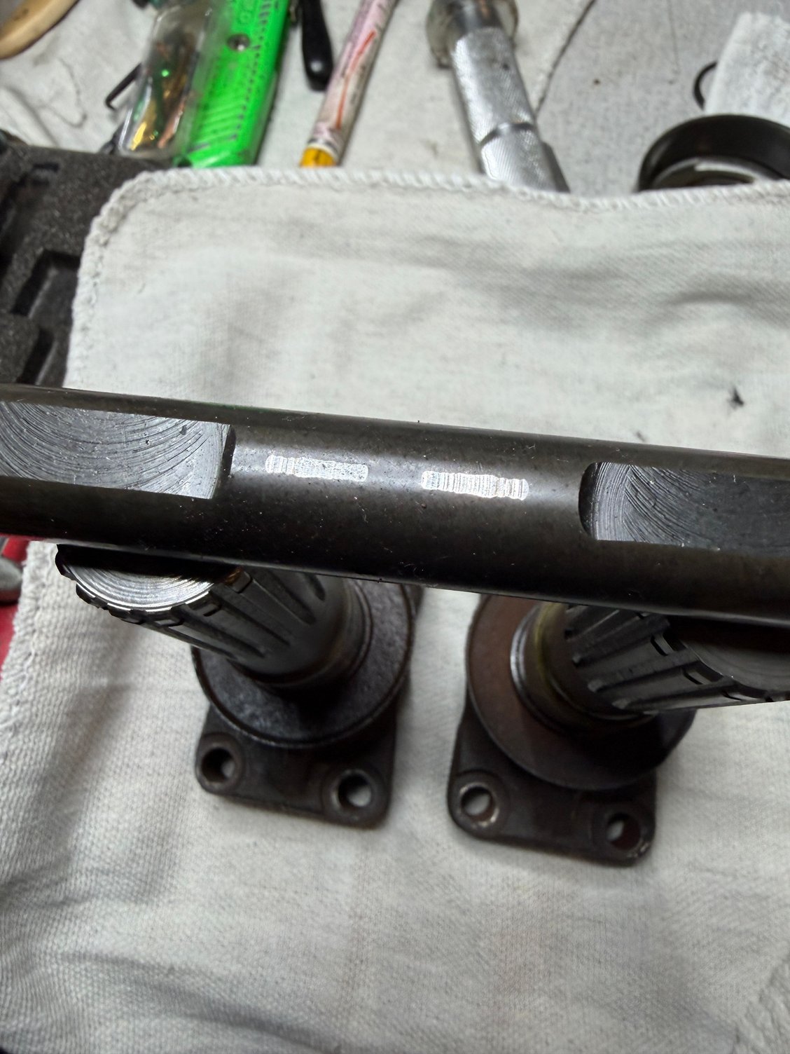 Cross shaft showing wear pattern from one axle.