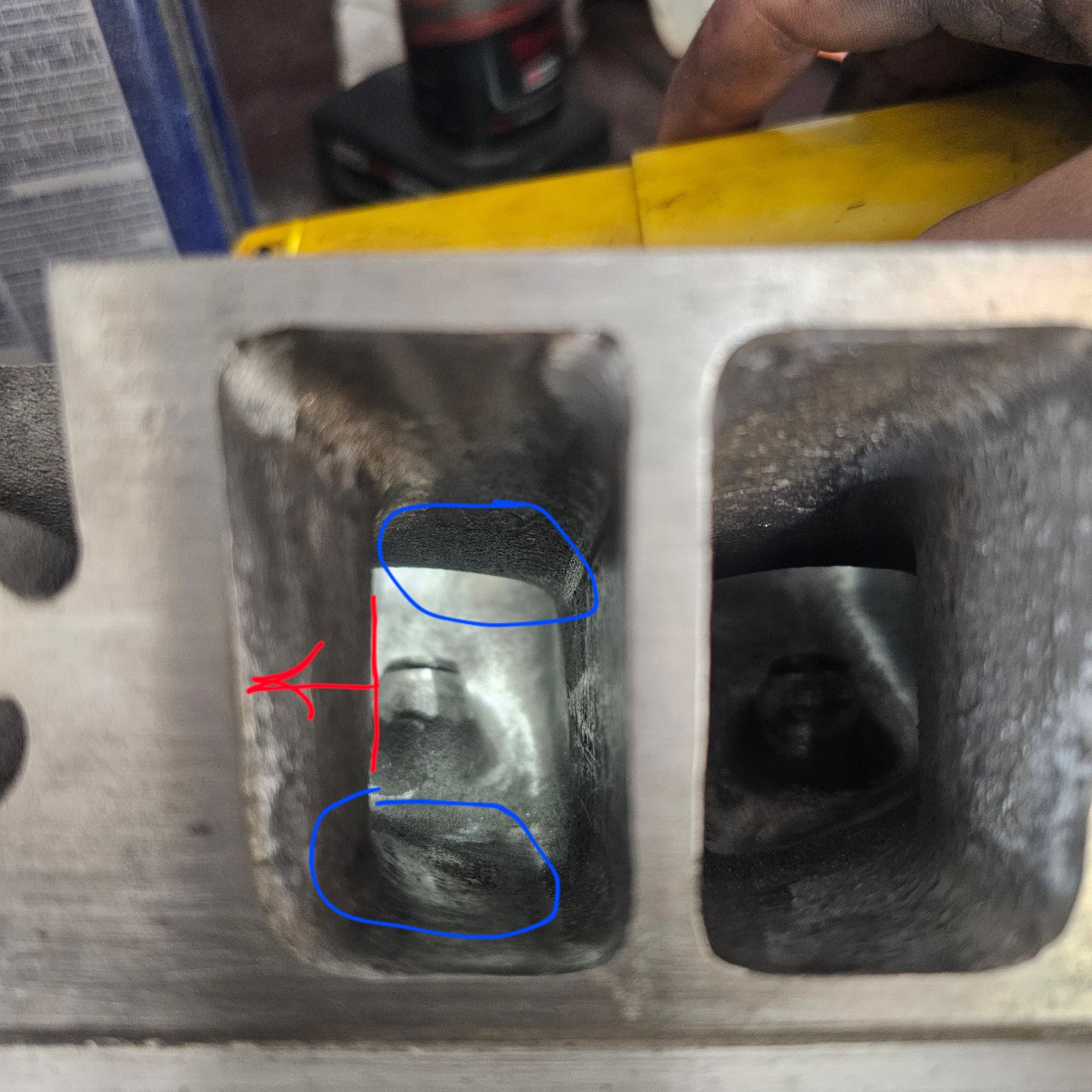 Pic 4: intake port has a bend on 1 wall. Its widest at the entryy then tapers in, then back out at the throat. Ive opened up the port entry and transitioned it into the rest of the port. Question 1 is should i grind away any more of the curved wall (move red line in the direction of the arrow) to get a more consistent diameter? Question 2 is should i grind away the areas in the blue circles to mantain a similar rectangular shape to the port entry, or do those curves help air flow into the bowl? 