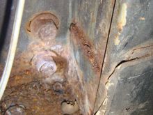 Internal: More clues behind driver's internal kick panel. Surface rust. But about 1/3 of small baby jar of loose rust flakes from somewhere..... five inch rust slot above.