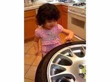 My daughter picking tire nipples.  Yeah, I used to store extra sets of tires and wheels in the kitchen and closet.