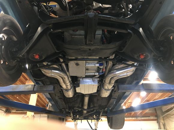 Made the transmission pan headers, slip on collectors, and 5” diameter mufflers, plus fabrication of a transmission cross member to clear the huge exhaust. Modified the dry sump pan to work in a Camaro 
