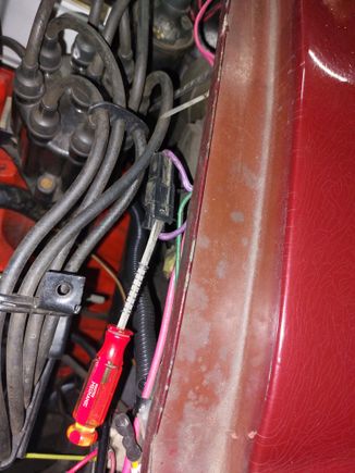 Use anything to hold the loop up. Don't bend it any further than necessary to clear the male wedge.