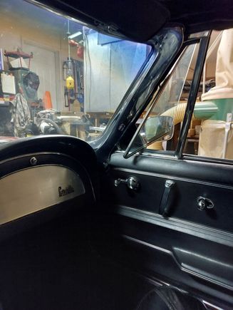 In driver's seat with wing fully open. It does cut off the view in the lower corner of the mirror