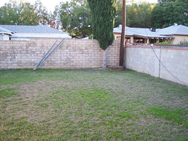 Here is the yard in Dec 2004 when we first moved in... a great blank slate- almost too many possibililties, but not a whole lot of room to do it in (land is $$$ here, so this was the max we could afford).