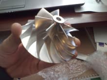 Billet aluminum compressor turbine wheel. "Wicked wheel". It was hard to tell if there were gains but i'm sure there are because the engineering of it makes sense (lighter weight and aggressive fin pattern).