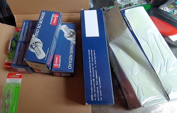 No labels on counterfeit box, and it's twice the size of the original Denso parts box