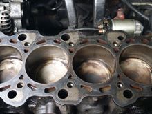 So before I put the gasket on, I did one last prep job on the block gasket surface, and cleaned debri from the bolt holes and the coolant holes and the oil holes, and also it was suggested to rub a little oil inside the piston well walls so it wont have a ruff start. So that's all done and the gasket has been placed. Please see the following pics
