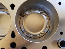 Valve reliefs of the Wiseco HD 1400 piston.  I believe the dot on each pistons represents timing side placement?