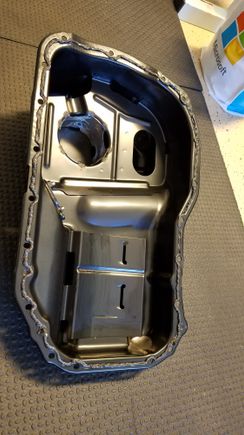 Laying down a bead of Black RTV to seal the buschur baffled oil pan to the block.