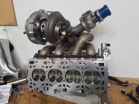 Evo X 4B11 head with Garrett Spec II GTX8576r turbo hanging off a stainless Sinco Manifolds masterpiece. Turbosmart Progate