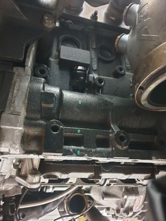 12AN (1/2NPT base) fitting installed into the front balance shaft tunnel. Installing onto the front of the block is critical because the oil is already flung onto the back of the block. The front of the block should be relatively "dry".