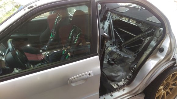 Rear door removed to install first main hoop from the kit. This will be the biggest piece behind the front seats hugging the B pillars 