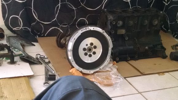 here i test fitted the flywheel  with the old oem flywheel bolts in which  i will use new ones after boring and re conditioning the crank shaft. Got my 4G64 bottom end for $100. Now its stripped totally. lol