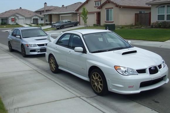 My Evo 8 and Roommate's Subbie
